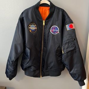 Old school bomber jacket with rapper Logic’s album patches